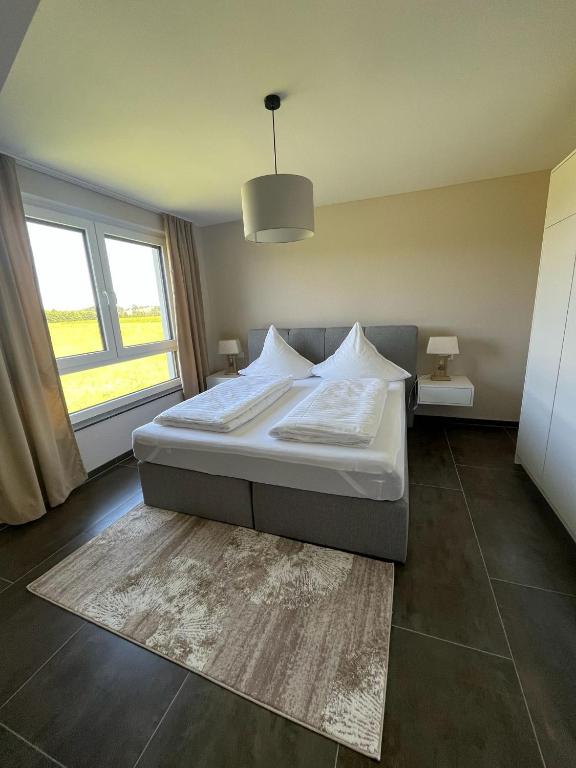 a bedroom with a bed and a large window at Apartment by Ela in Alpirsbach