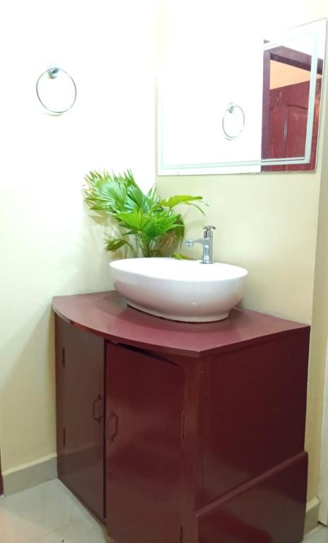 a bathroom with a sink and a mirror at Happy Stay in Vagamon