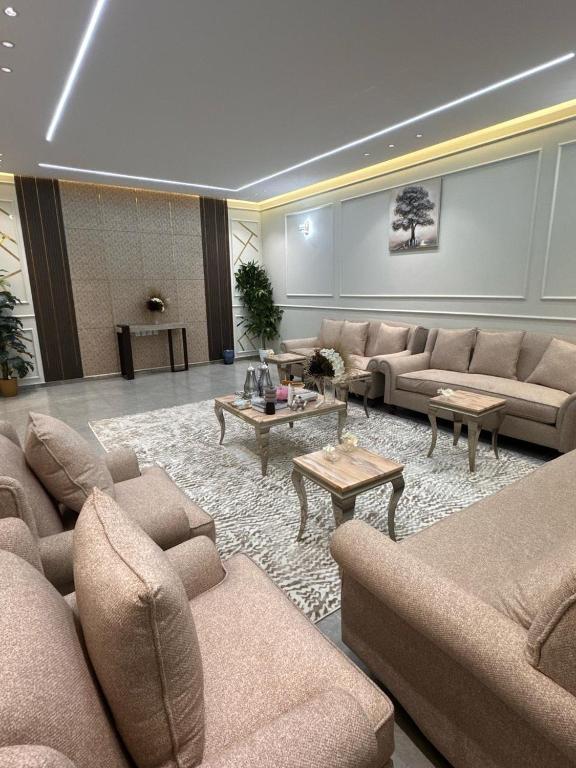 a large living room with couches and tables at شالية درة الرحاب in Buraydah