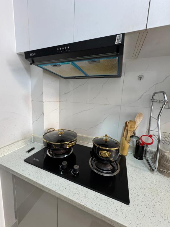 two pans sitting on top of a stove in a kitchen at Jambo luxury living in Marimbeti
