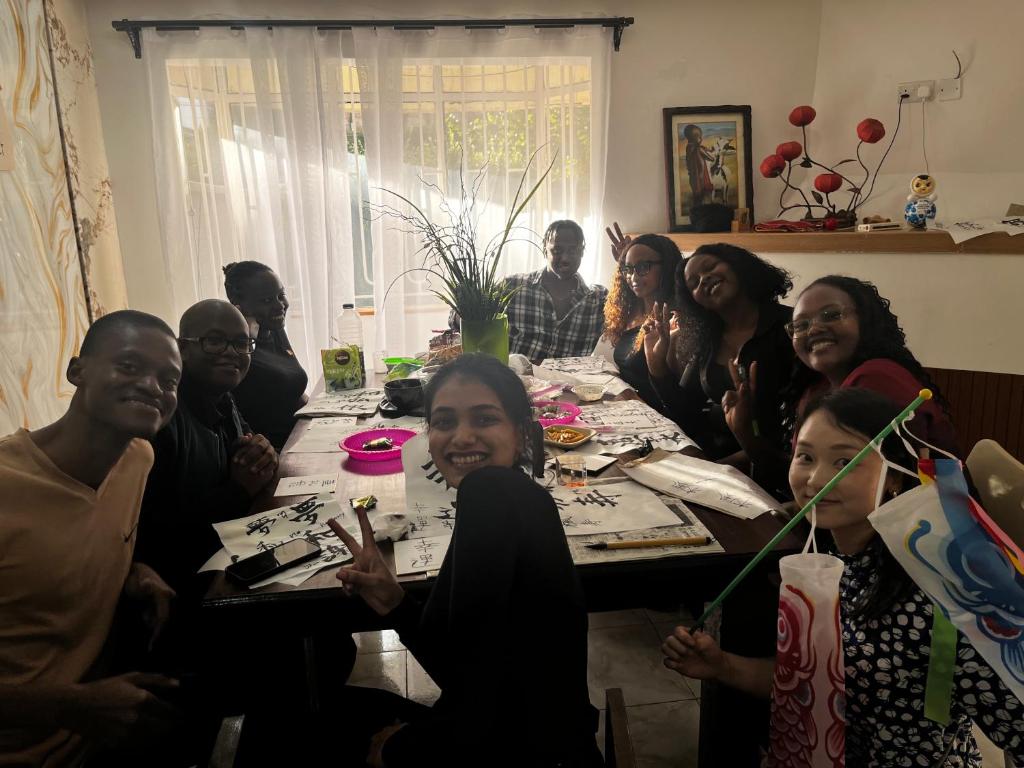a group of people sitting around a table at WeniZani Backpackers Hostel Nairobi in Nairobi