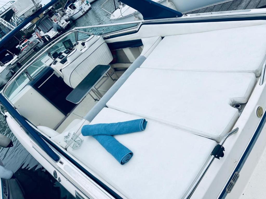 a boat with two seats and a table on it at VINA ROMANCE - Romantic Boat Stay in Lisbon Marina in Lisbon