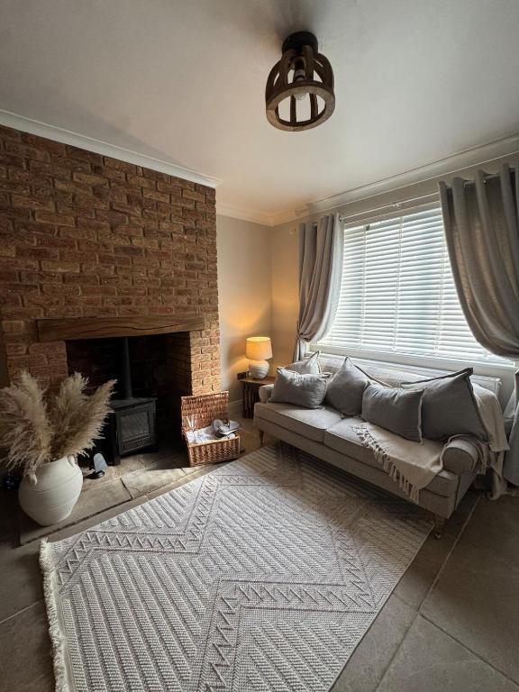a living room with a couch and a fireplace at Harehills House in Killingbeck