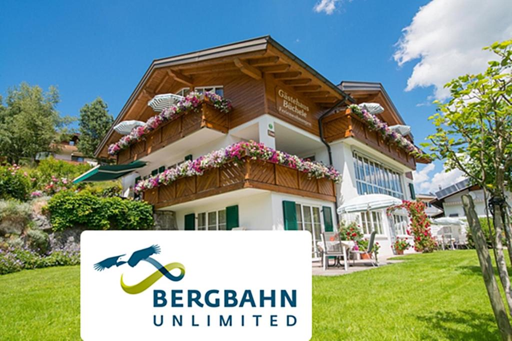 a building with a sign in front of it at Ferienwohnung Gästehaus Büchele Kleinwalsertal in Hirschegg