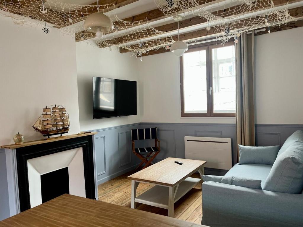 a living room with a couch and a table at l'Ocean in Dieppe