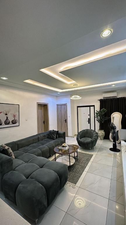 a large living room with couches and a table at Premium Height in Ikate