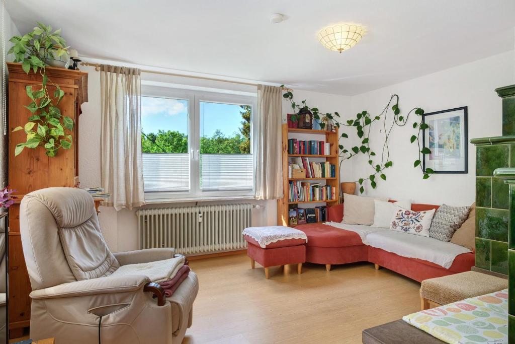 a living room with a couch and a chair at Ferienwohnung Am Seebach, 80 Qm in Titisee-Neustadt
