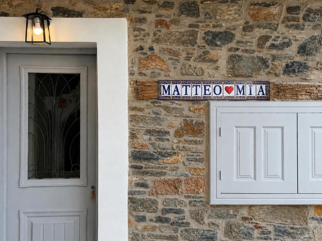 a door and a street sign next to a brick wall at Samos Vista Azzurra 2 in Samos
