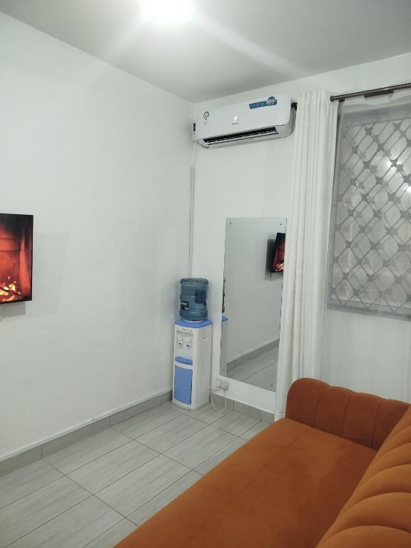 a living room with a couch and a window at Chasy luxury in Mtwapa