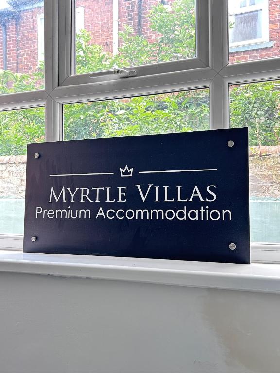 a sign in a window in a building at Myrtle Villas in Hull