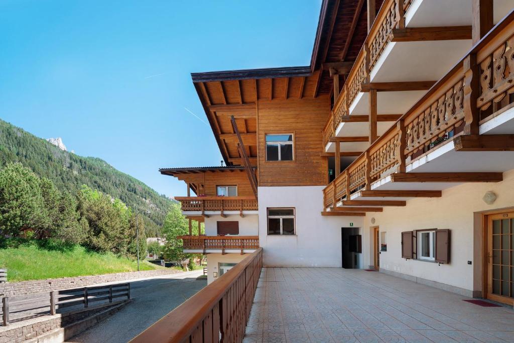 a balcony of a building with wooden balconies at Appartamenti Lella in Vigo di Fassa
