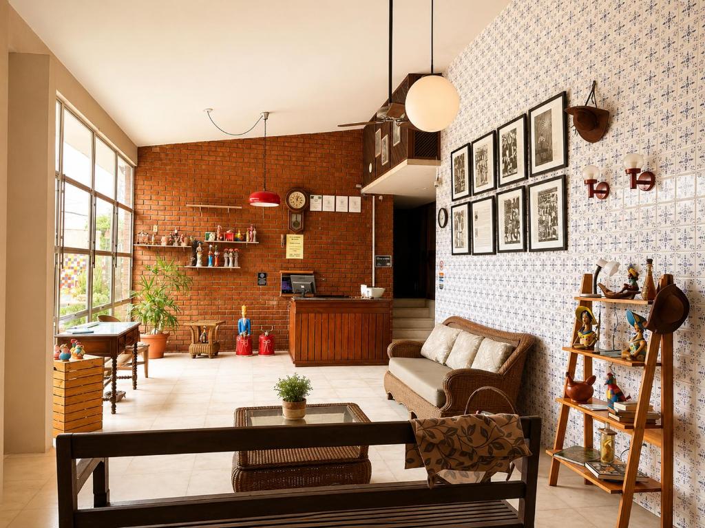 a living room with a couch and a table at Hotel Pousada Casuarinas in Recife