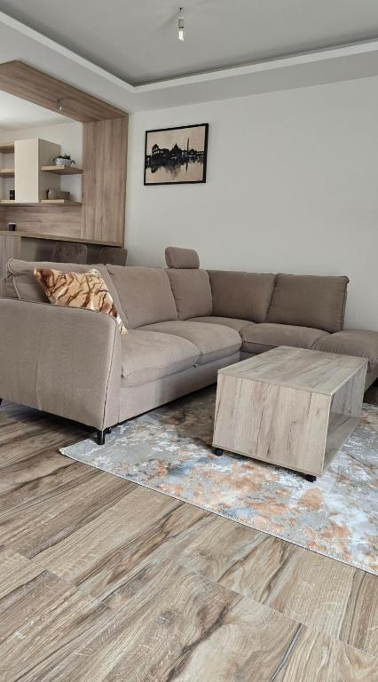 a living room with a couch and a coffee table at Lux studio - Vrh Đevojka in Borje