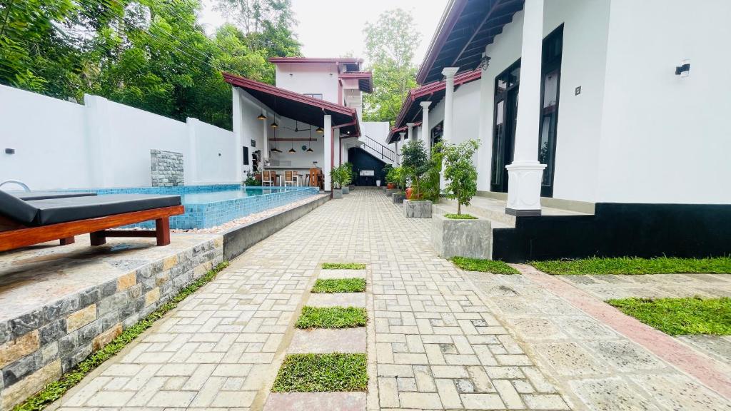 a courtyard of a house with a swimming pool at Thara Inn Villa in Dickwella