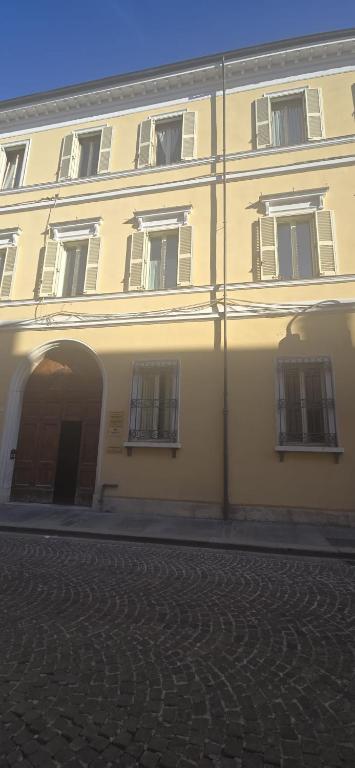 a large white building with an arch in front of it at Gabici Suite Ravenna in Ravenna