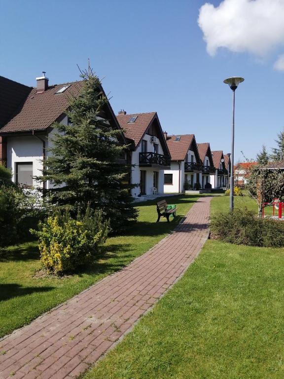 a brick walkway in front of some houses at Apartament Jaśkowy in Żarnowska