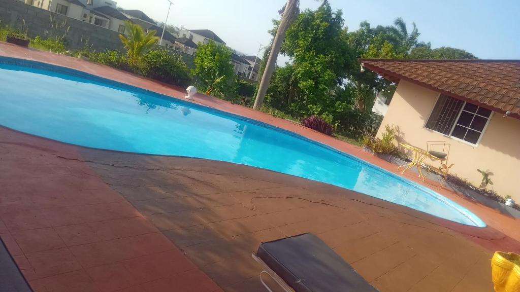 a large swimming pool in a yard with a house at Tambell Haven in Runaway Bay
