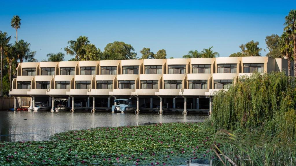 a large building with cars parked in front of it at Capri Waters Country Club in Mulwala
