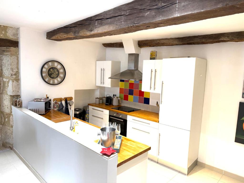 a kitchen with white cabinets and a white refrigerator at Maison Girasol Sleeps 4 w Pets On Request in Eymet