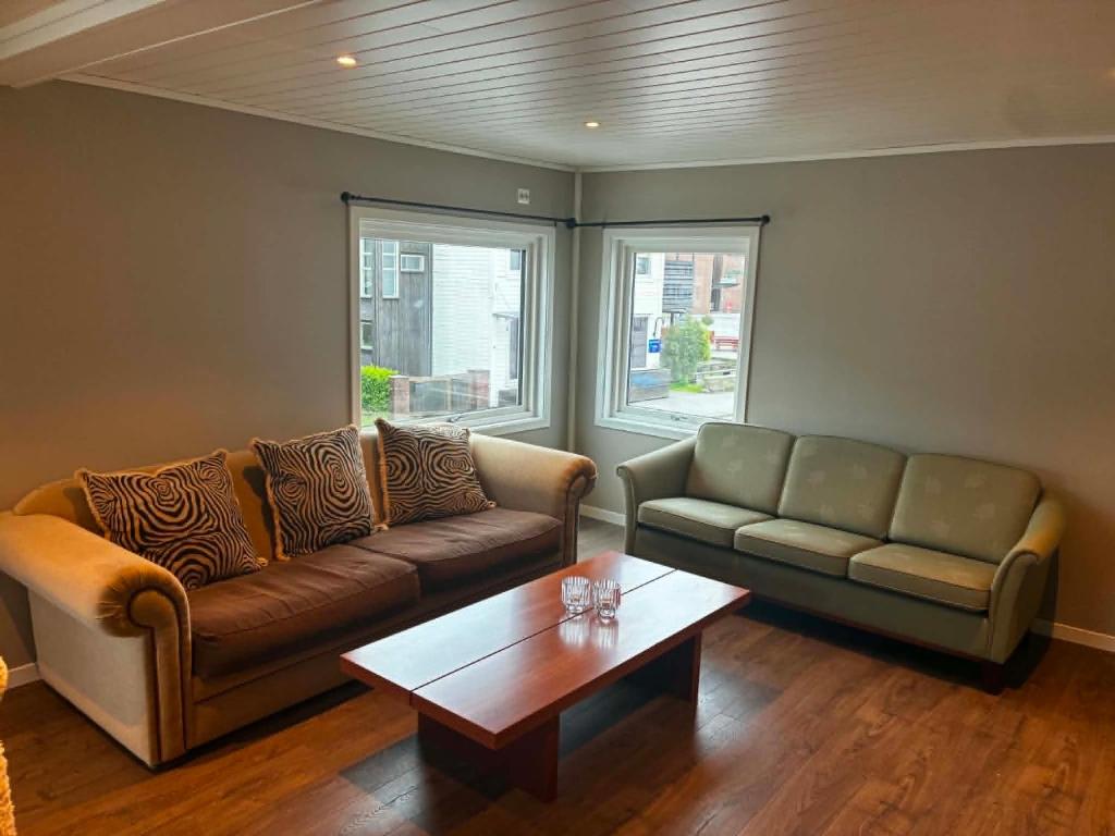 a living room with a couch and a coffee table at Bedify Lodge Sokndal in Sokndal