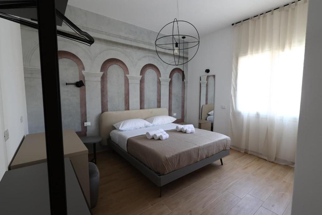 a bedroom with a bed with two towels on it at Ferries apartament in Trapani