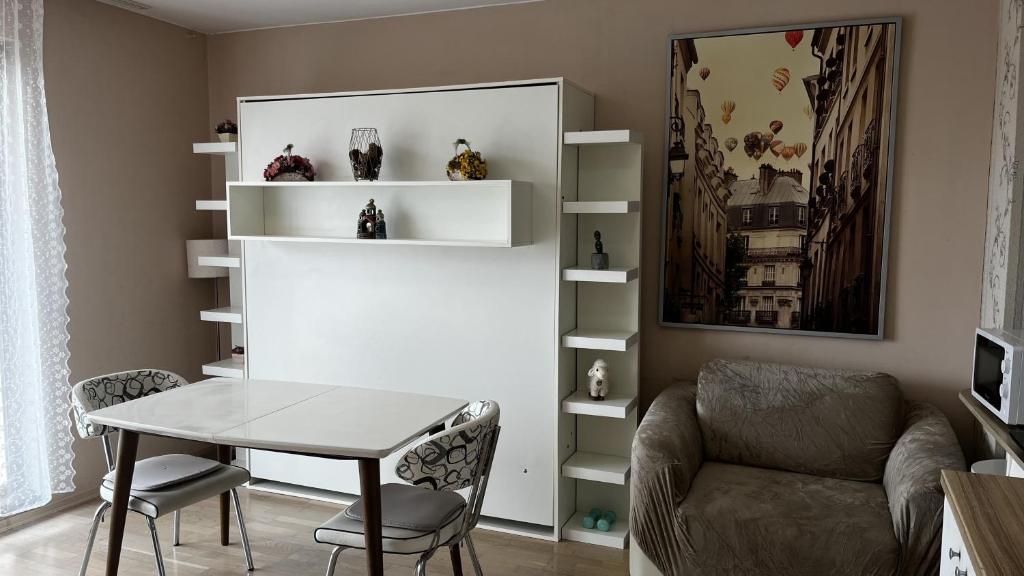 a living room with a table and a chair at Briz in Varna City