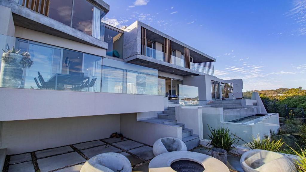 an exterior view of a house with large glass windows at Pure Emotions Beach House in Knysna