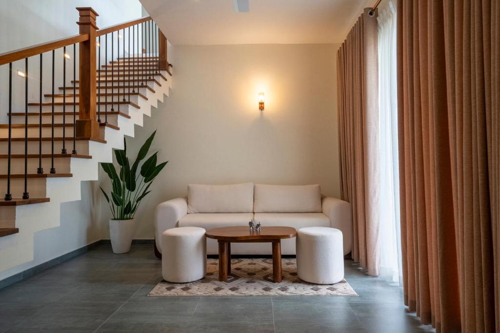 a living room with a couch and a table at 79 by TerraLume in Nugegoda