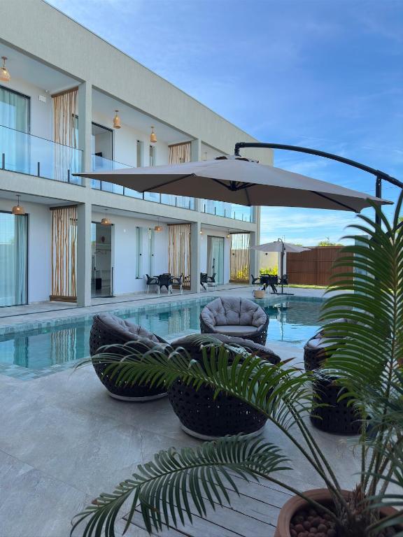 a pool with chairs and an umbrella in a building at CASA AL MARE in Prado