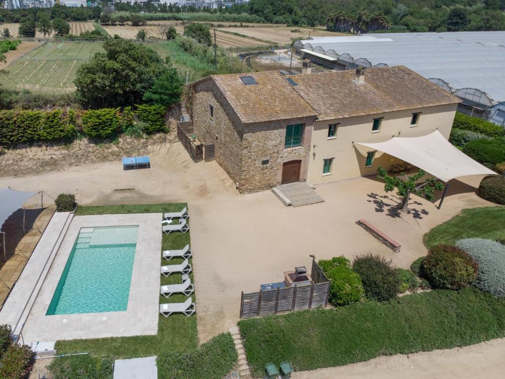 an aerial view of a house with a swimming pool at Mas Tortós in Palafolls
