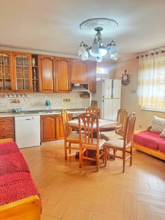 a kitchen and dining room with a table and chairs at N'Baz Apartment Lezhë in Lezhë