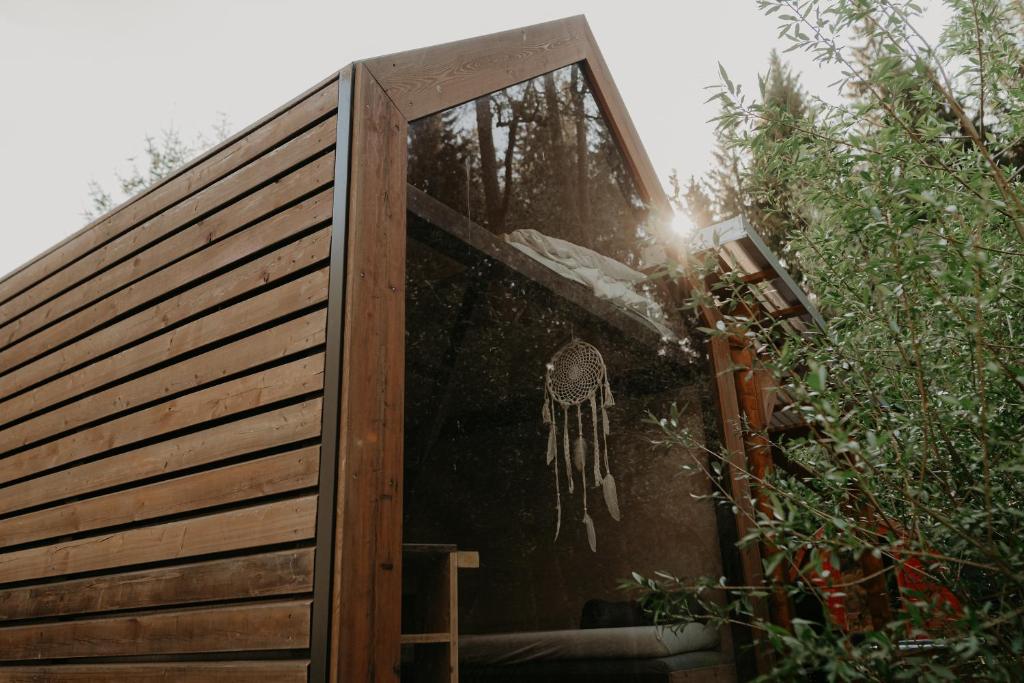a sliding glass door with a dream catcher on it at Glamping Všímarský potok in Malšín