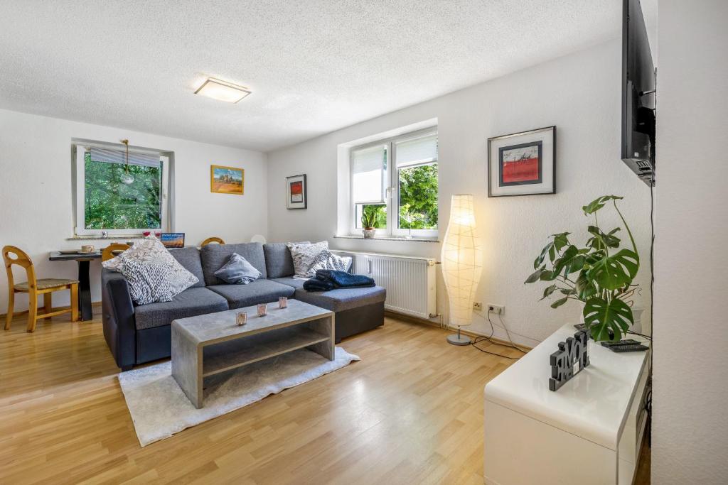 a living room with a couch and a table at Ferienwohnung Halde Hoheward in Recklinghausen