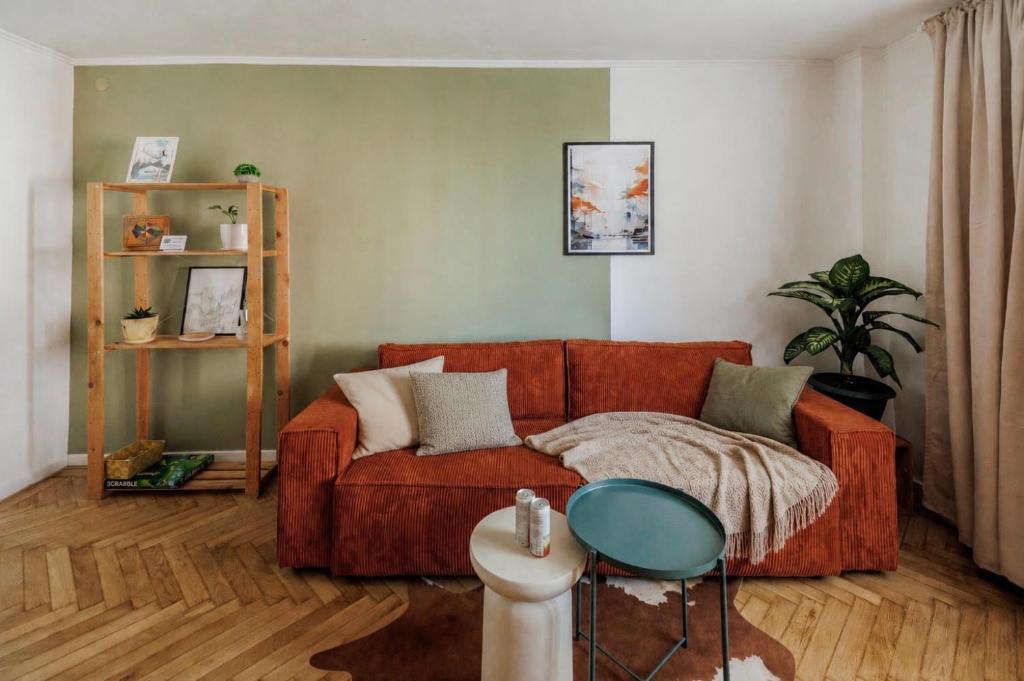 a living room with a couch and a table at ZAZA Apartament - central area, with balcony in Târgu Jiu