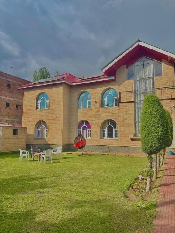 a building with tables and chairs in front of it at Giggle in Srinagar
