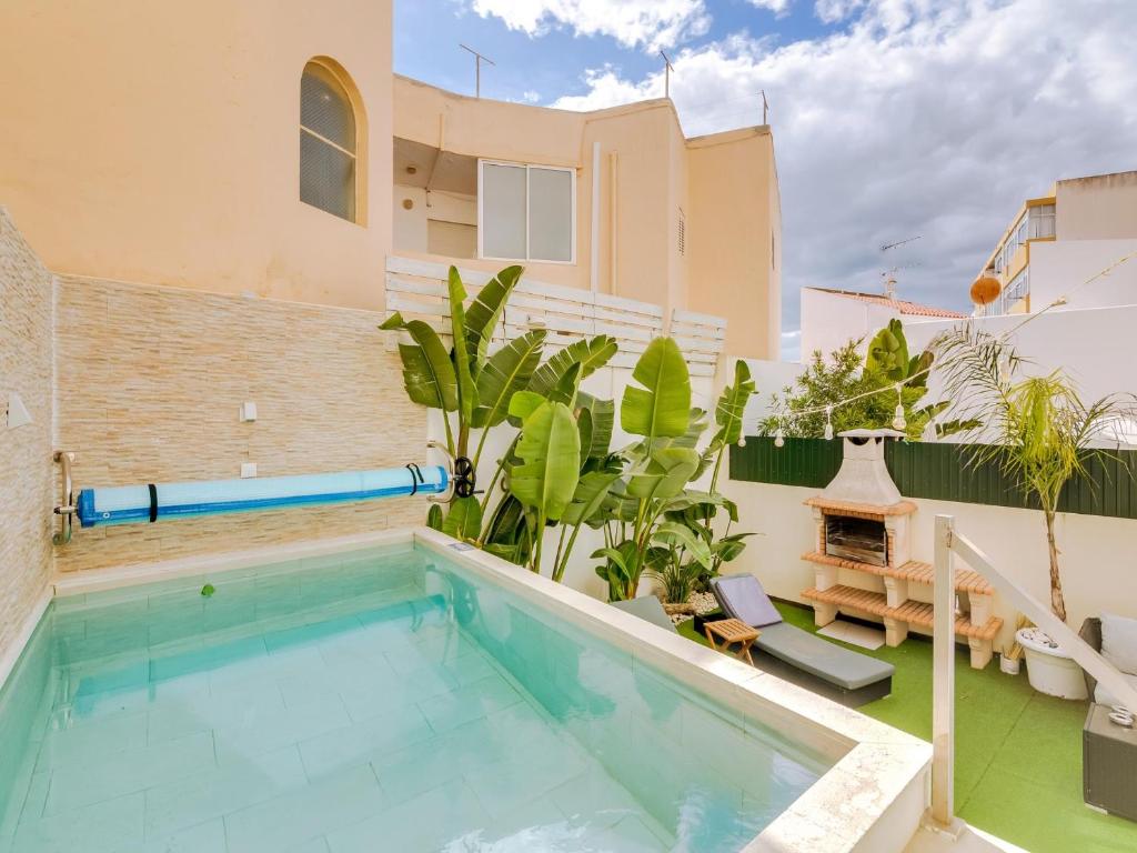a swimming pool in the backyard of a house at Villa Monica with Private Pool and Jacuzzi in Quarteira