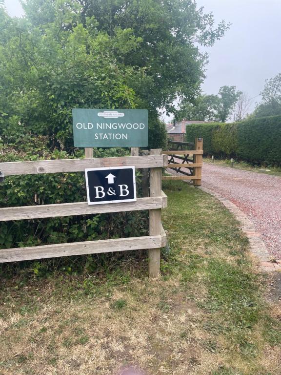 ein altes Bahnhofsschild von Kingsford an einem Holzzaun in der Unterkunft Old Ningwood Station Bed & Breakfast, Ningwood, Isle of Wight PO41 0TG in Shalfleet