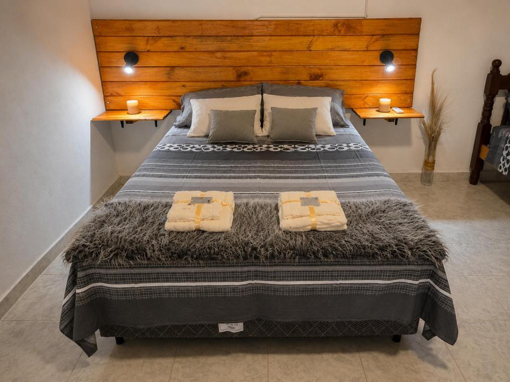 a bedroom with a large bed with two towels on it at Alojamientos Adele II in San Miguel
