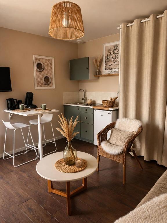 a living room with a table and a kitchen at Ker Sonia in Angers