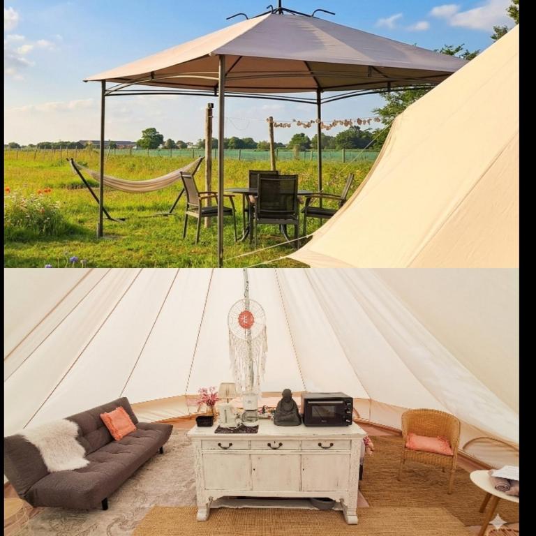 a canvas tent with a table and a couch at Bell-tent Luna met uitzicht in Hensbroek