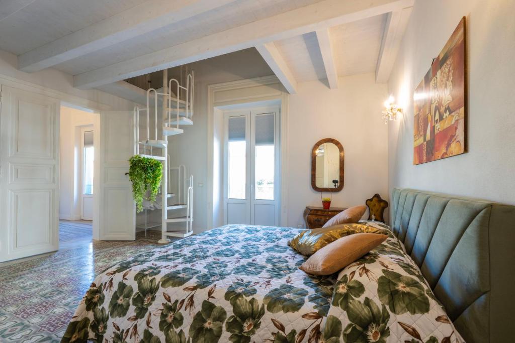 a bedroom with a bed with pillows on it at Chez Moi in Trapani