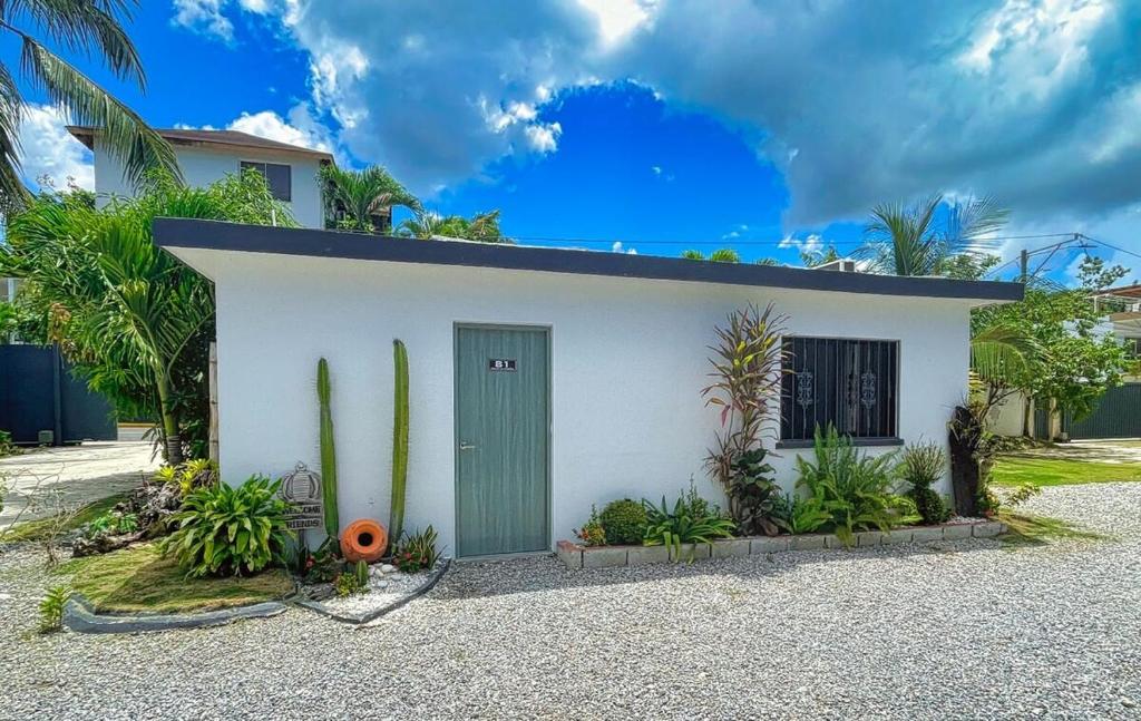 a small white house with a green door at Villa La Dueña Perfect Escape in Las Terrenas