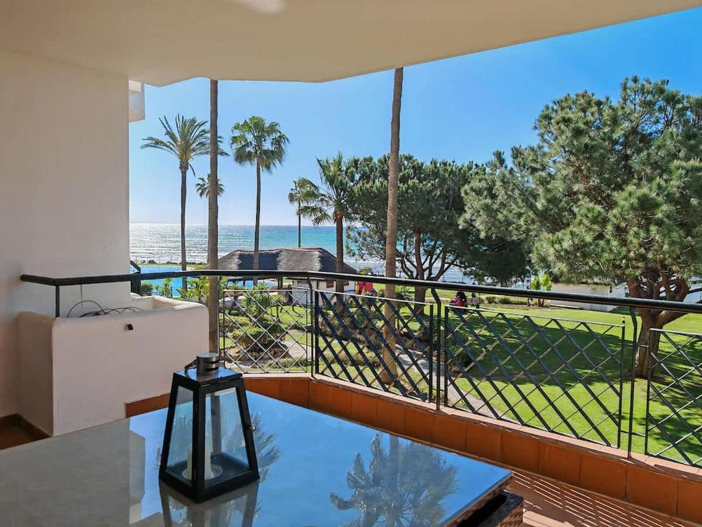 a room with a balcony with a view of the ocean at Sea View - Pool view - Beach Front - 25 meter to beach in Málaga
