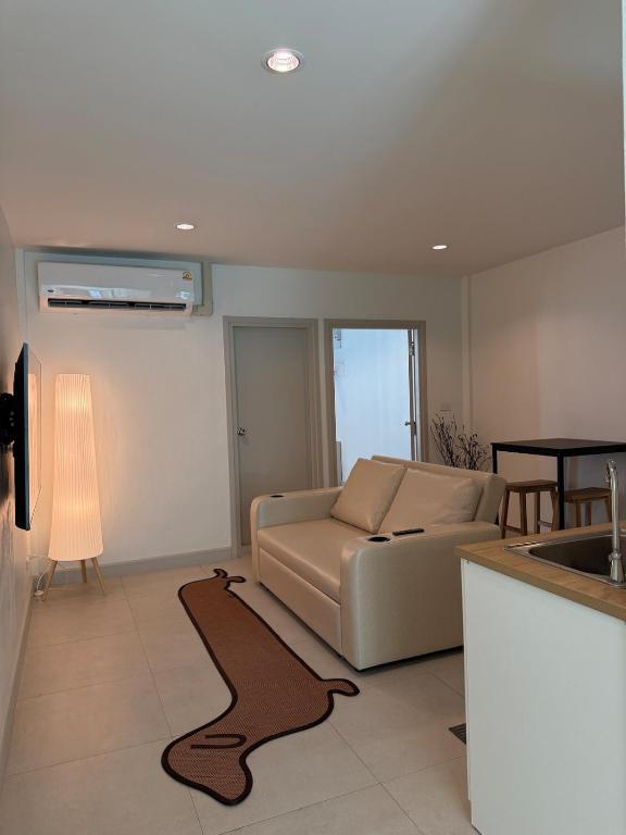 a living room with a couch and a table at 2 Bed & 2 Bath Suite, 4th floor in Ban Bang Toei (1)