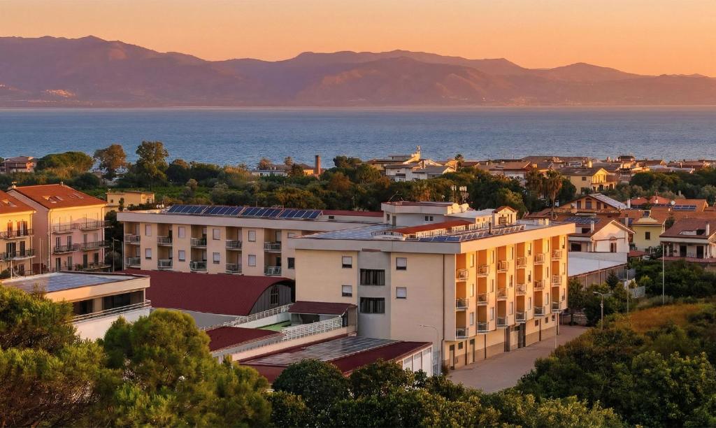 a view of a city with the ocean in the background at Aparthotel Codex in Rossano