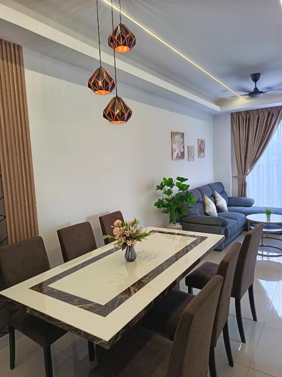 a living room with a table and a couch at Piccadilly Residence by LMS ipoh in Ipoh