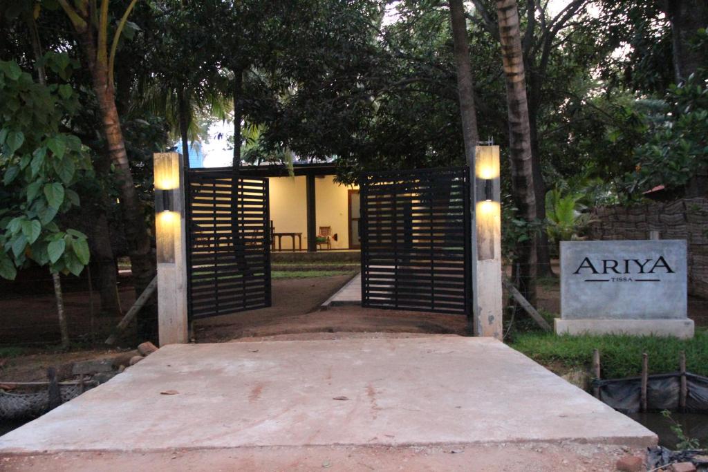 a gate in a park with lights on it at Ariya Tissa in Tissamaharama