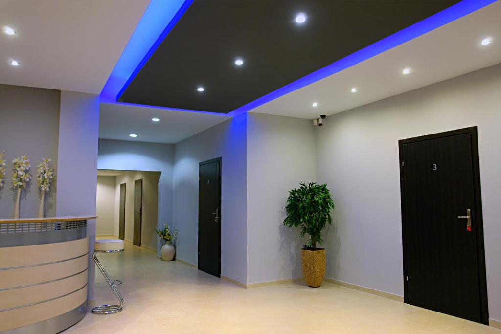 an office lobby with a blue light on the ceiling at Greyhouse in Jaworzno