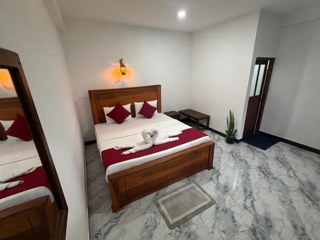 a bedroom with a dog laying on a bed at Duo Haven Inn Ella in Ella
