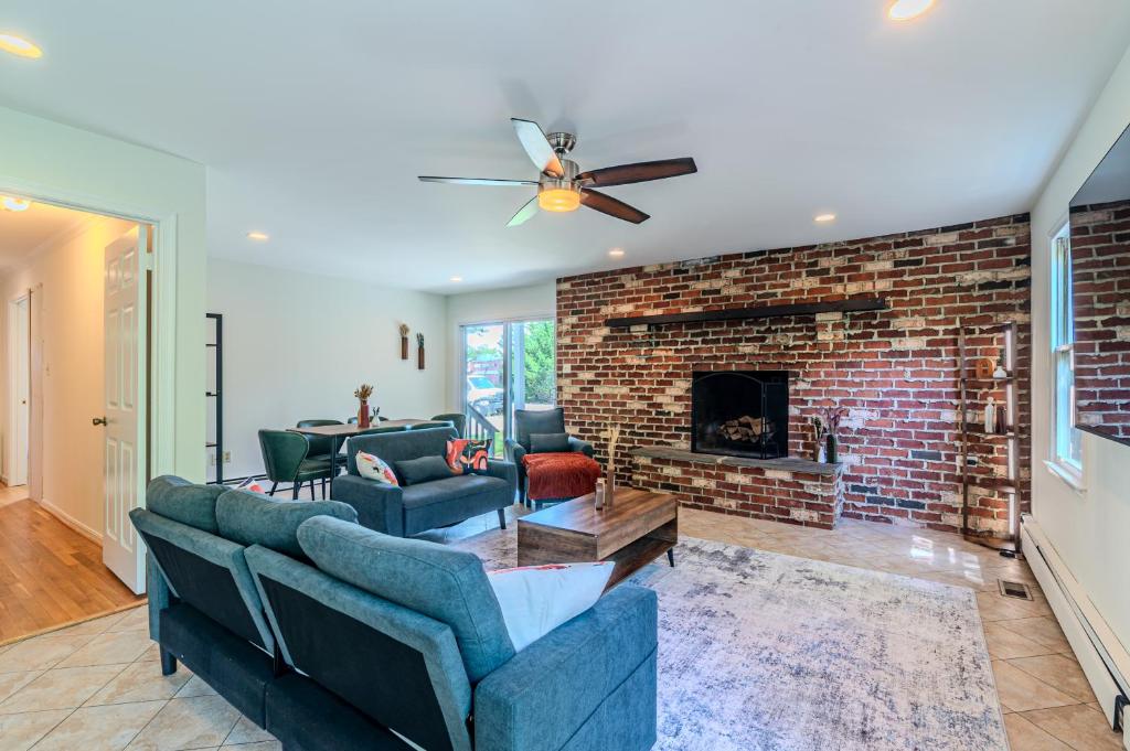 a living room with couches and a brick fireplace at Arlington Suite in Arlington